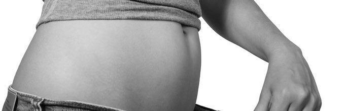 Woman Trying to Fit into Tight Jeans